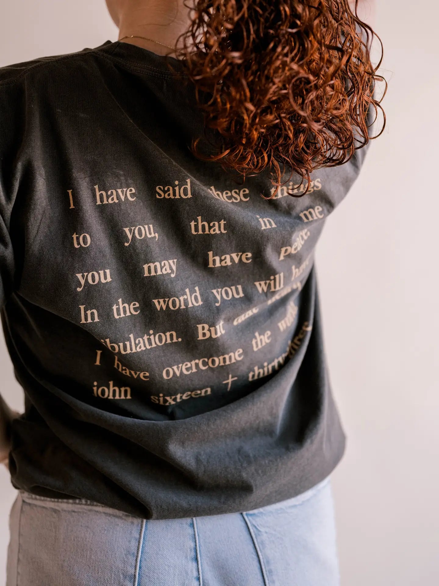 "i have said these things to you, that in me you may have peace. In the world you will have tribulation. But take heart, i have overcome the world. john sixteen thirty-three" graphic tee BACKSIDE