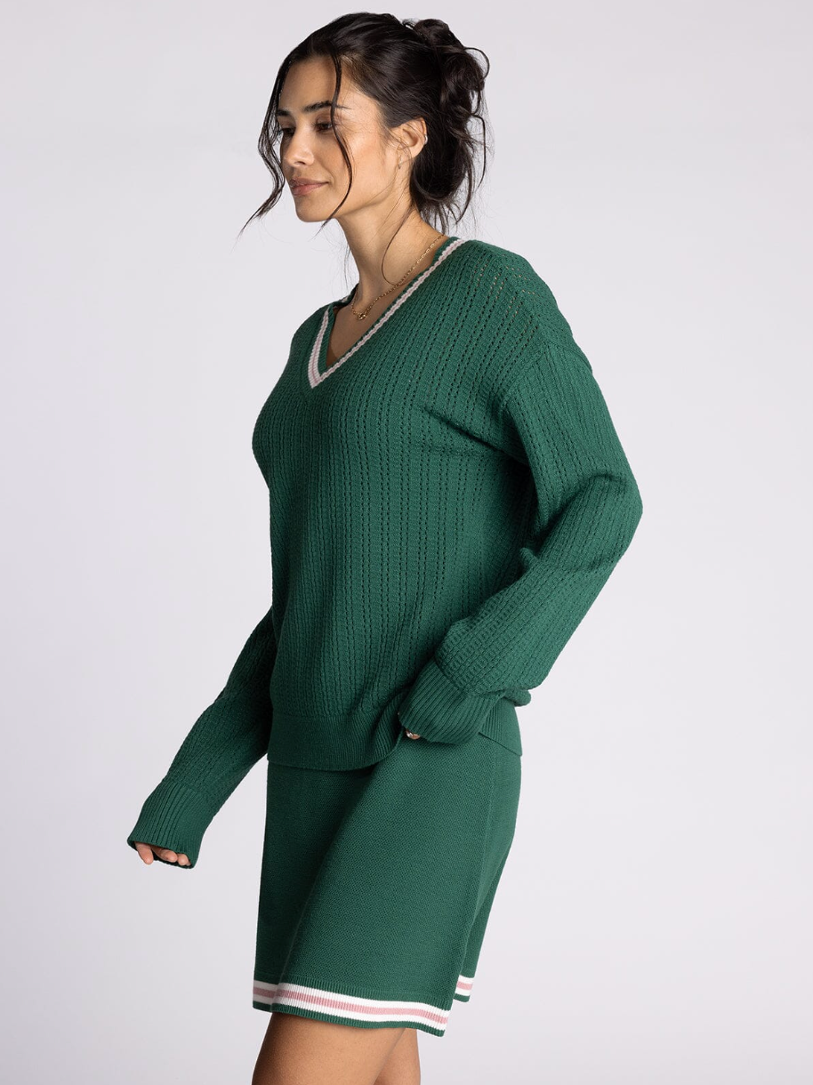 green v neck sweater with pink detailing