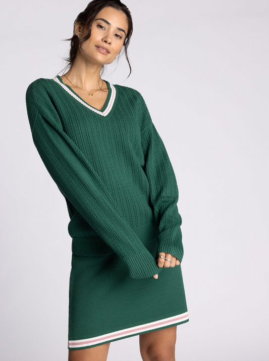 green v neck sweater with pink detailing