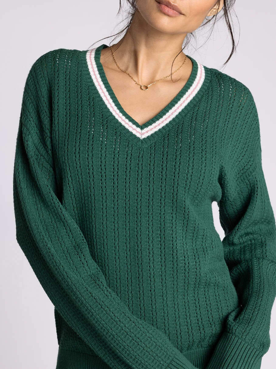 green v neck sweater with pink detailing
