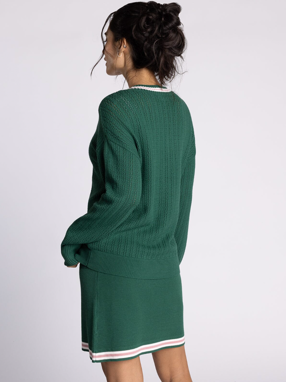 green v neck sweater with pink detailing