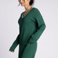green v neck sweater with pink detailing