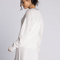 white v neck sweater with blue detailng