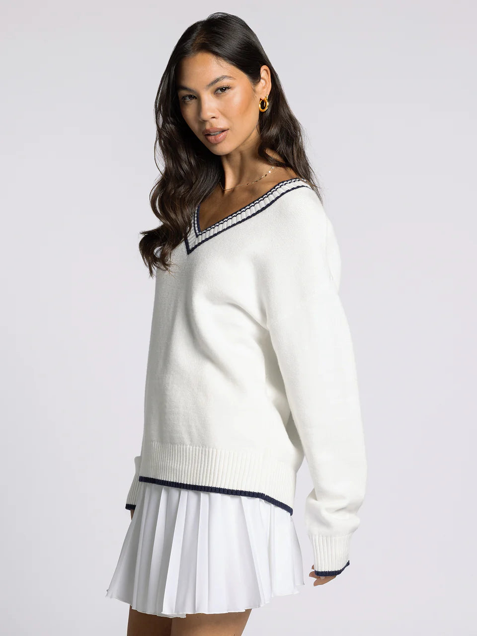 white v neck sweater with navy accents
