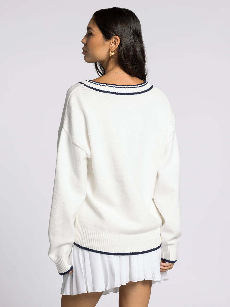 white v neck sweater with navy accents