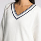 white v neck sweater with navy accents