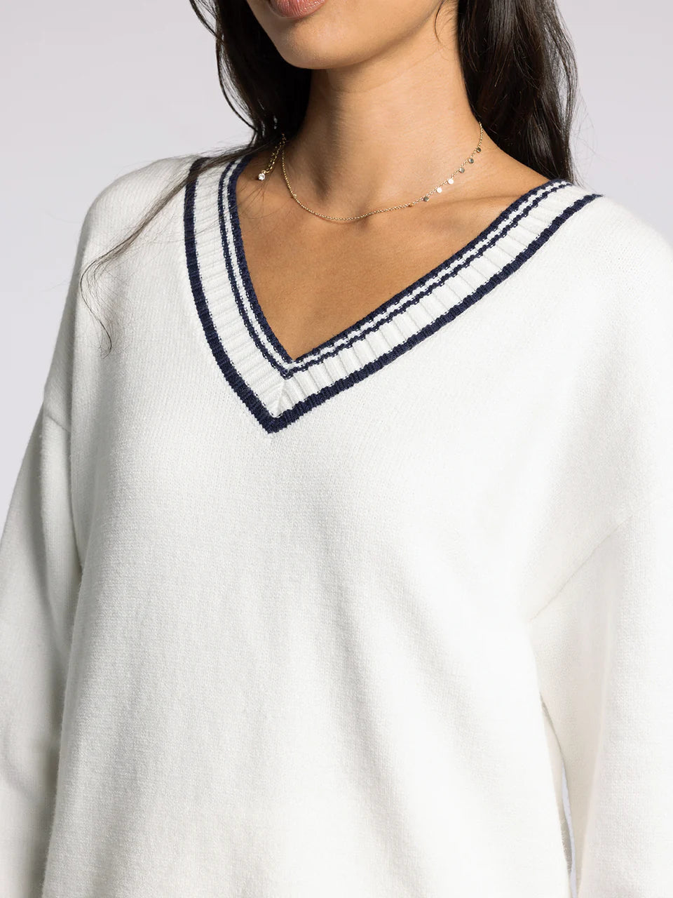 white v neck sweater with navy accents