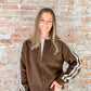 brown zip sweater with white stripes on sleeves