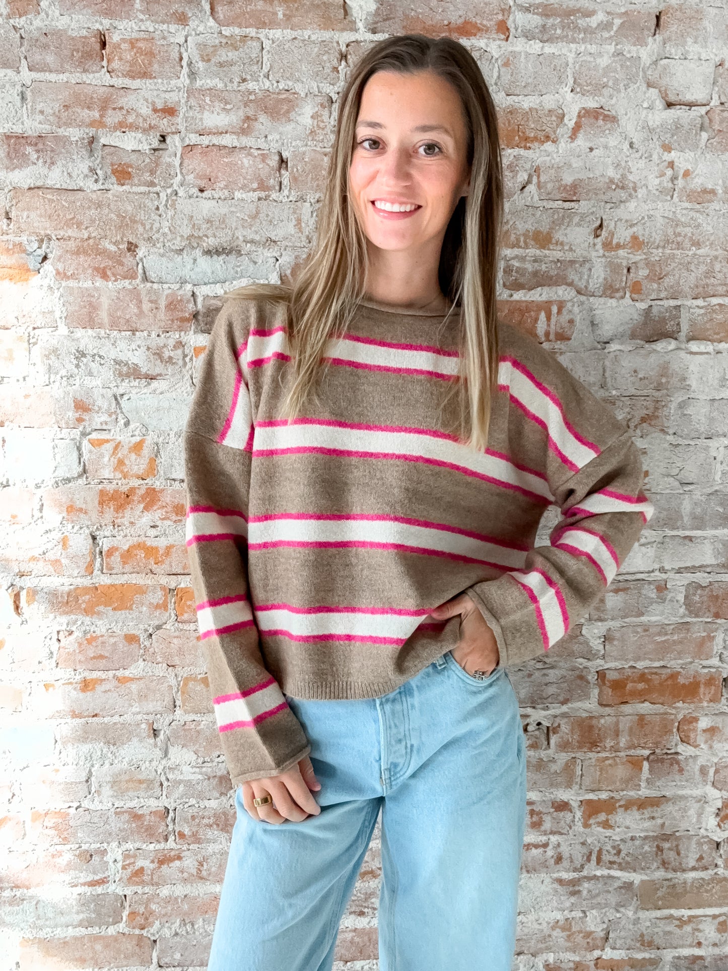 brown sweater with pink and white stripes