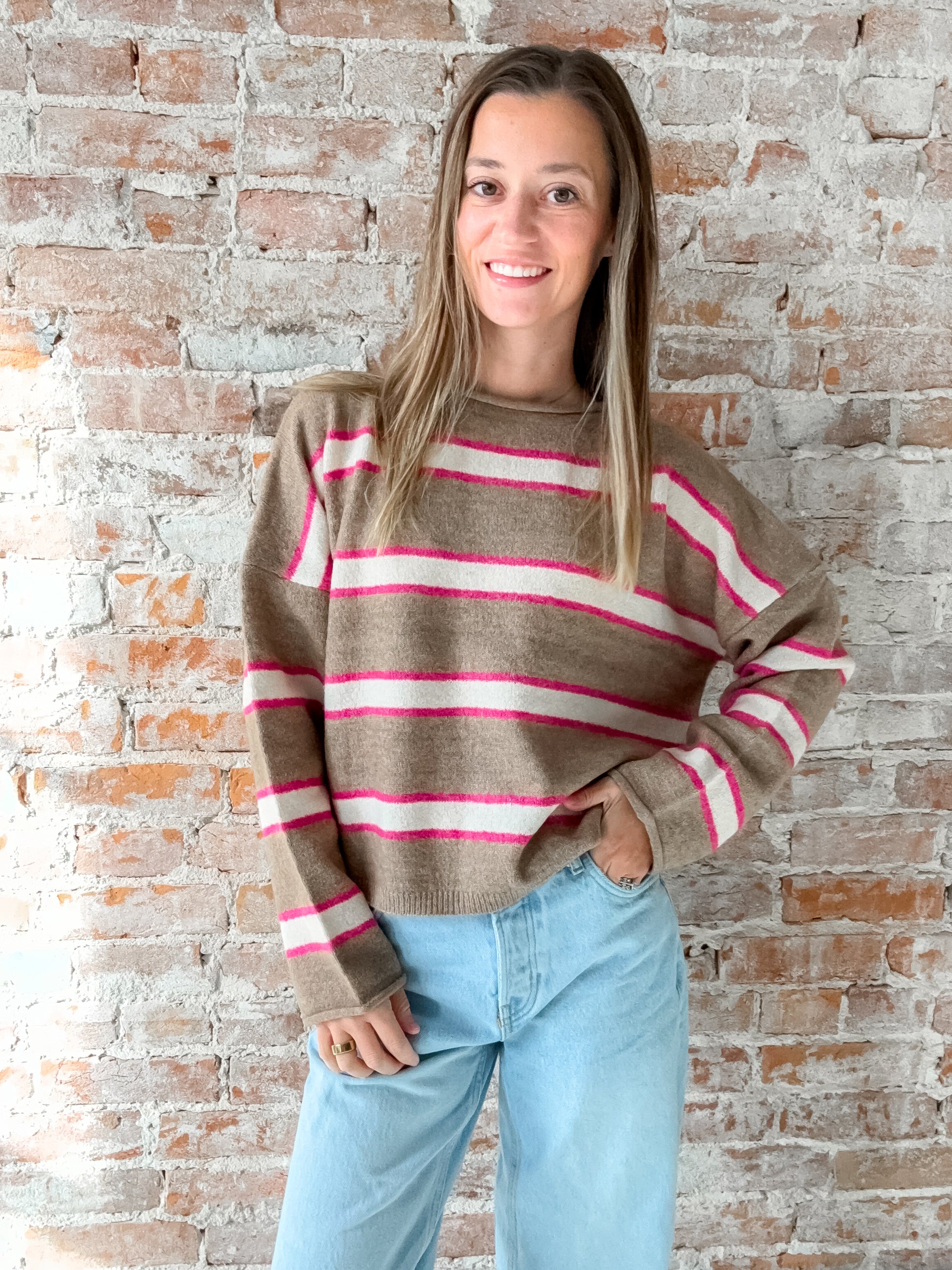 brown sweater with pink and white stripes